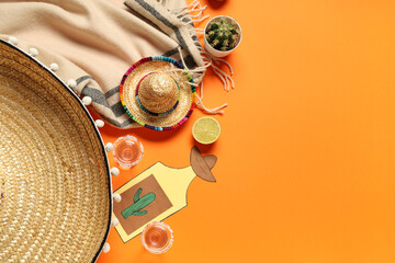 Mexican sombreros with tequila, cactus and decor on orange background. Cinco de Mayo