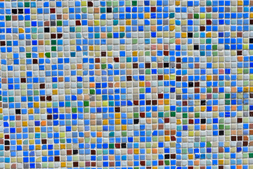Fototapeta premium A vibrant and colorful mosaic tile pattern with blue, yellow, and brown tiles, ideal for backgrounds and decorative designs. 