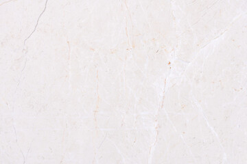 Close-up of light beige marble texture showcasing fine veins and natural patterns, perfect for backgrounds and design elements.
