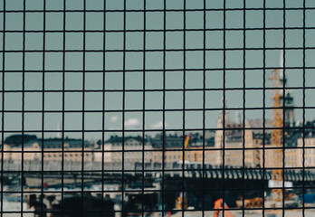 Close up of a fence against a cityscape
