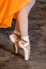 Detail of feet of a classical dancer wearing pointe shoes