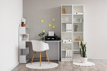 Interior of office with workplace, pin board and printer