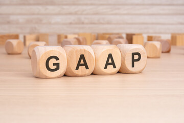 short word english text GAAP on a wooden cubes with wooden background