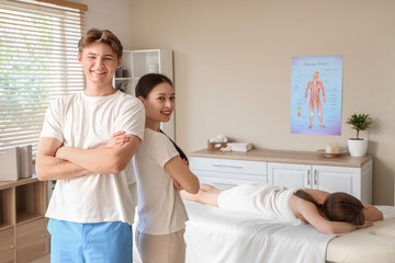 Fototapeta premium Portrait of massage therapists with client in spa salon