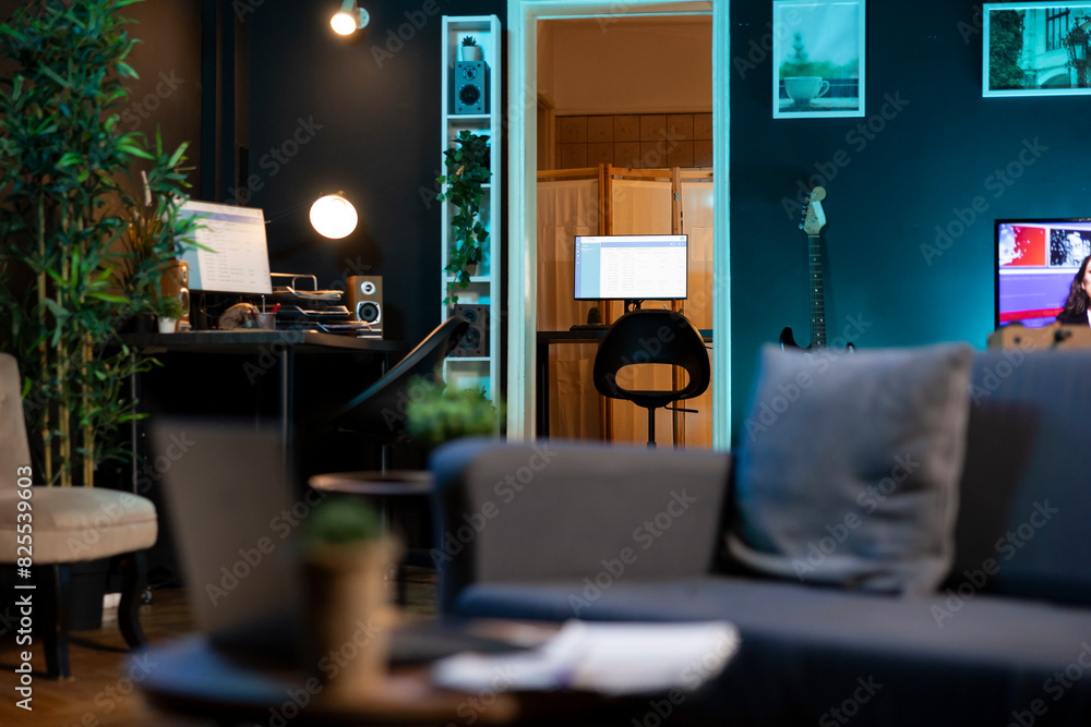 Aufkleber stylish empty apartment with artwork on walls and computer screen left open at night showing softwar