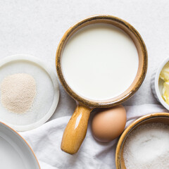 Overhead view of Mise en place of ingredients for making coco bread, ingredients for making jamaican bread on a table, process of making coco bread