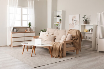 Interior of stylish living room with chest of drawers, sofa and coffee table