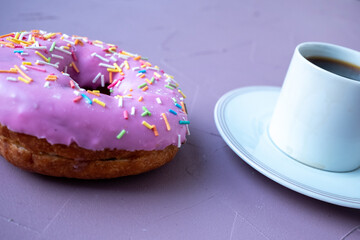 cup of coffee and pink donuts on pink background	