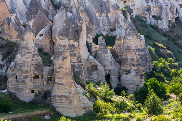 Spectacular landscape of Cappadocia with towering rock formations housing ancient cave dwellings...