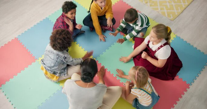 Kindergarten, children and hands with game in circle for development, growth and activity. Teacher, high angle and playful student on mat in class for sensory education, learning and creative skill