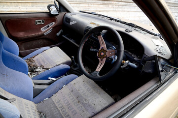 BANGKOK, THAILAND - May 23, 2024: Old car parked for a long time beside the road in Thailand.