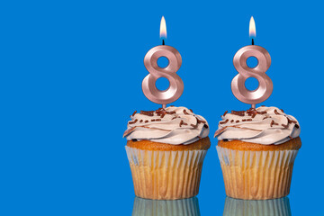 Birthday Cupcakes With Candles Lit Forming The Number 88.