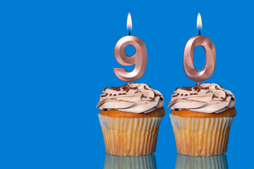 Birthday Cupcakes With Candles Lit Forming The Number 90.
