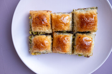  Local Turkish baklava on a white plate in a 360 degree rotating display case