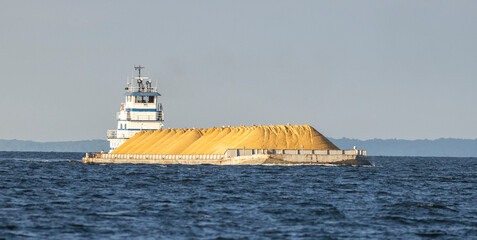 A tug pushing a barge of sand up the Chesapeake Bay.