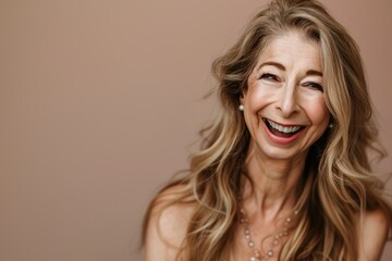 Fototapeta premium A woman laughing joyfully with flowing hair, wearing a pearl necklace, against a soft gradient background, capturing pure happiness and laughter