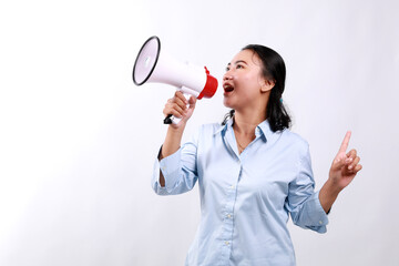 Happy beautiful Asian woman talking on megaphone to sideways while pointing other side. isolated on...