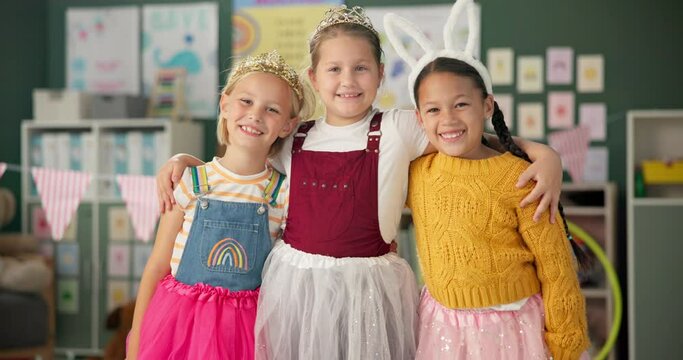 Happy girls, friends and hug with costume in class for dress up or casual day at school together. Portrait of children or kids with smile for halloween in princess outfit, tutu or fairy tale in room