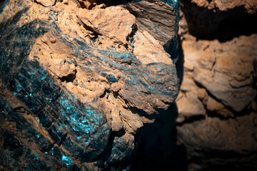 Lava formations, stones, black basalt in the rocks closeup on a volcano terrain.