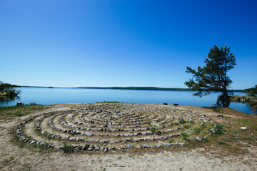 Spiral labyrinth made of stones on the coast