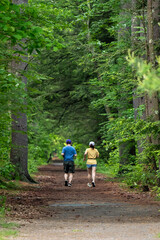 Obraz premium a couple running hiking in the woods