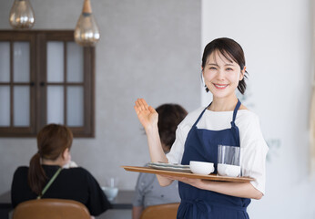 Cafes, catering and restaurant staff saying “Welcome” to customers Looking at the camera