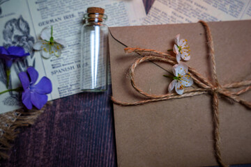 Mystical still life in vintage style with empty flasks, letters and newspaper clippings