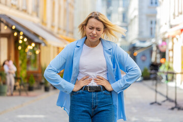 Caucasian young woman traveler feeling sudden strong abdominal stomach ache gastritis problem....