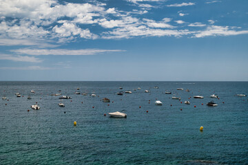 Boats anchored near the rocky beach in Calella de Palafrugell, a fishing village on the Costa Brava in Catalonia, Spain.

