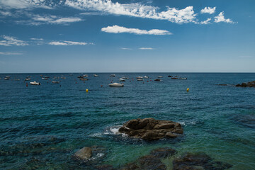 Boats anchored near the rocky beach in Calella de Palafrugell, a fishing village on the Costa Brava...