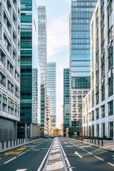 Obraz premium A city street with tall buildings and a clear blue sky