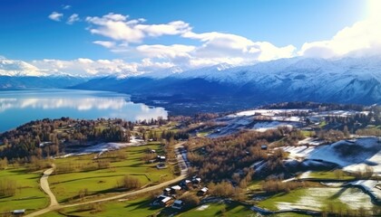 Fototapeta premium Stunning spring views of the countryside and green grass and beautiful flowers, with rolling hills and fertile soil, against a backdrop of vast mountains