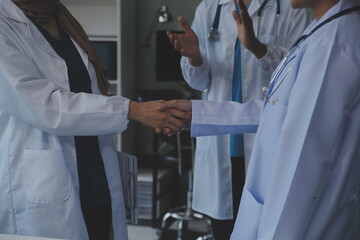 The medical team joins hands and works togetherGroup of scientists joining hands to create...
