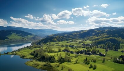 Obraz premium Stunning spring views of the countryside and green grass and beautiful flowers, with rolling hills and fertile soil, against a backdrop of vast mountains