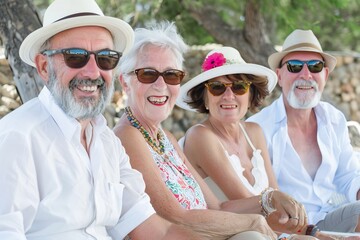 Group of happy seniors having fun on the beach on a sunny day.