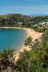 Tourists relaxing on the beach at Kaiteriteri, Tasman, New Zealand.