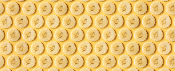 Background image of thinly sliced banana fruit arranged in an orderly fashion