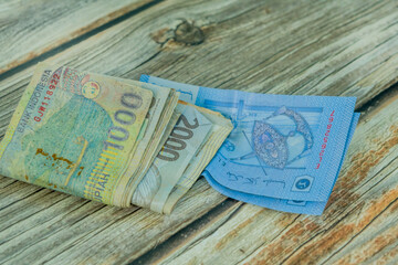 A stack of Indonesian currency notes on a wooden table