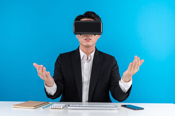 Asian businessman looking thorough VR connecting metaverse meeting in business world news...