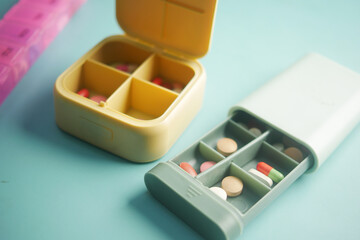 close up of medical pills in a pill box on table 