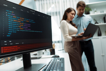 Coding software screens newest creative website on working desk against on developers program...