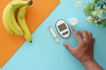 top vie of diabetic measurement tools and banana on a table 