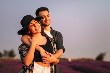 Young couple on a romantic date in a lavender field.