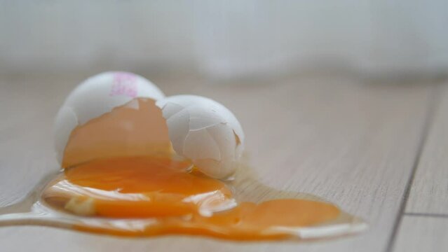 Fresh broken egg in kitchen floor