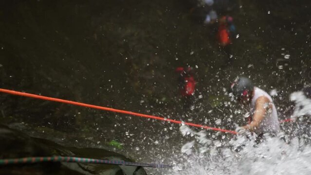 amateur rappelling down a waterfall, Slow Motion