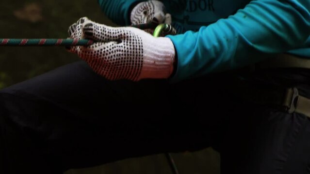 amateur gear, gloves, rappelling down a waterfall, close up Slow Motion