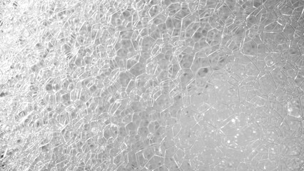 Explore a microscopic wonderland as this unveils intricate white bubbles, resembling tiny galaxies,...