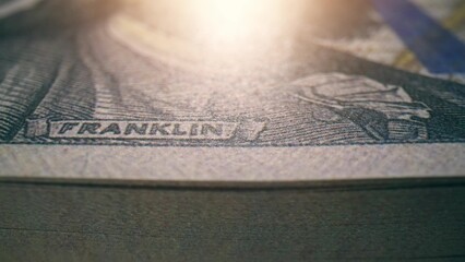 A close-up of crisp one hundred dollar banknotes, highlighting their intricate design. Sustainable...