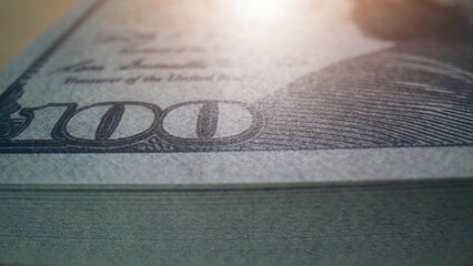 Intriguing macro shots of 100 USD banknotes, capturing the texture and precision of American bills....