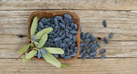 Blue Honeysuckle berries situated on rustic wooden table